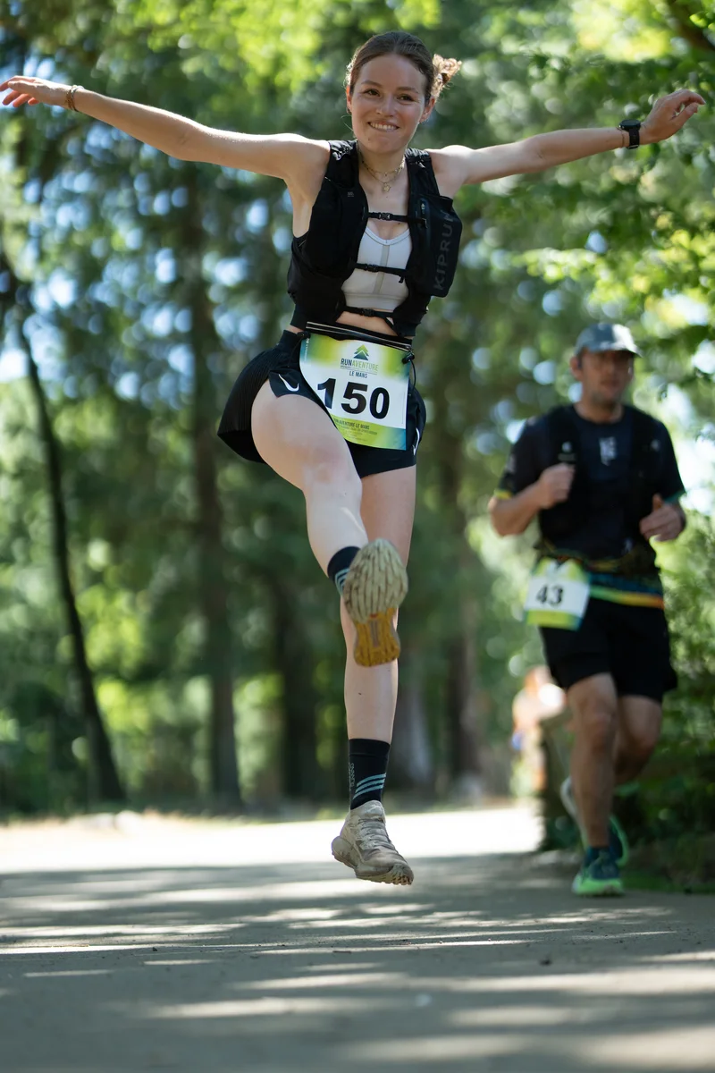 Runner with bib 150, mid-jump